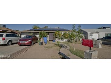 Charming single-story home features solar panels and a well-maintained front yard at 6101 N 31St Dr, Phoenix, AZ 85017