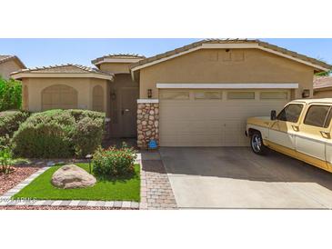 Charming single-Gathering home with a two-car garage, lush landscaping, and stone accents at 6620 S 16Th Dr, Phoenix, AZ 85041