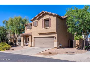 Charming two-story home featuring a neutral color scheme, attached two-car garage, and well-maintained landscaping at 1145 E Lowell Ave, Gilbert, AZ 85295