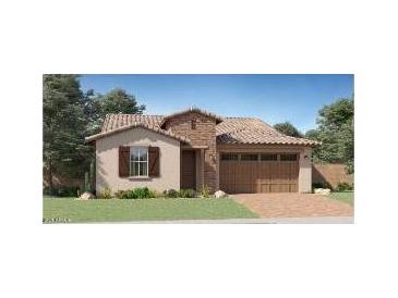 Charming single-Gathering home showcasing a stone facade, a two-car garage, and a perfectly manicured front lawn at 15824 W Kendall St, Goodyear, AZ 85338