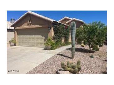 Charming home showcasing desert landscaping and a two-car garage at 2110 E Williams Dr, Phoenix, AZ 85024