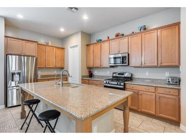 Spacious kitchen island with granite countertops and stainless steel appliances provides plenty of cooking space at 4630 E Navigator Ln, Phoenix, AZ 85050