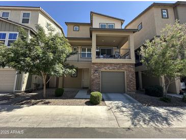 Inviting two-story home features a covered balcony, low maintenance landscaping and a convenient attached garage at 631 W Winchester Dr, Chandler, AZ 85286