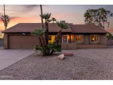 Charming single-Gathering home boasting a landscaped front yard and attached two-car garage at 6424 E Aire Libre Ln, Scottsdale, AZ 85254