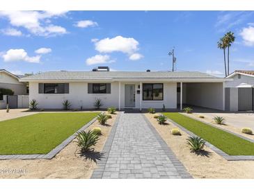 Charming home featuring a well-manicured front yard and a welcoming walkway at 6723 E 1St Ave, Scottsdale, AZ 85251