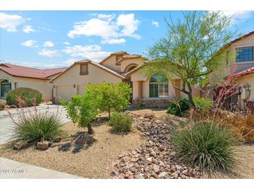 Charming single-Gathering home with well-manicured landscaping, a two-car garage, and a tile roof at 719 W Milada Dr, Phoenix, AZ 85041