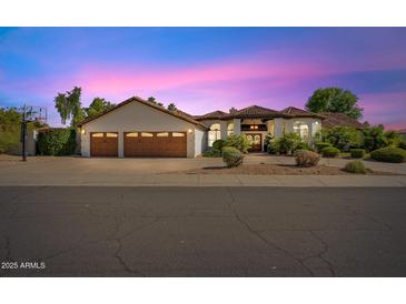 Beautiful single-story home with three-car garage and lush landscaping at 10205 E Corrine Dr, Scottsdale, AZ 85260