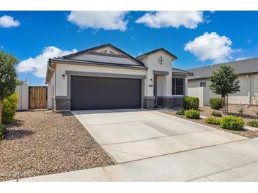 Charming single-story home with a well-manicured lawn and a two-car garage at 1281 W Highland Rd, San Tan Valley, AZ 85143