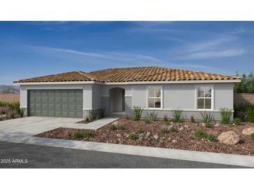 Charming single-story home featuring a tile roof, two-car garage, and desert landscaping in the front yard at 18221 E Zuza Dr, Gold Canyon, AZ 85118