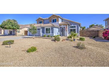 Charming two-story home featuring desert landscaping, decorative stone accents, and a welcoming front entrance at 1937 W Burgess Ln, Phoenix, AZ 85041