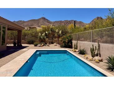 Backyard swimming pool surrounded by desert landscaping and mountain views at 23516 N 119Th Way, Scottsdale, AZ 85255