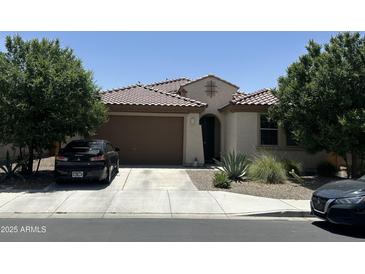 Charming single-story home with a well-manicured lawn and a two-car garage at 25931 W Deer Valley Rd, Buckeye, AZ 85396
