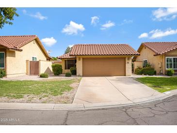 Charming single-level home with a well-maintained lawn, a two-car garage and a terra cotta tile roof at 4790 E Navajo St, Phoenix, AZ 85044