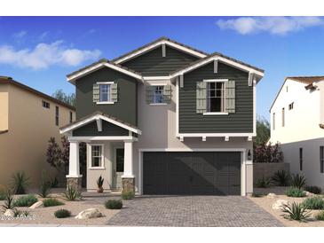 Charming two-story home featuring a two-car garage, stone accents, and a well-manicured desert landscape at 8030 W Griswold Rd, Peoria, AZ 85345