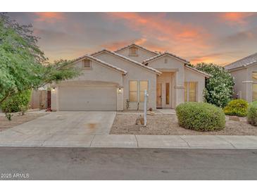 Charming single-story home with a two-car garage and low-maintenance desert landscaping at 8968 W Adam Ave, Peoria, AZ 85382