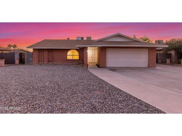 Charming single-story brick home featuring a two-car garage and low-maintenance gravel front yard at 17220 N 55Th Ave, Glendale, AZ 85308