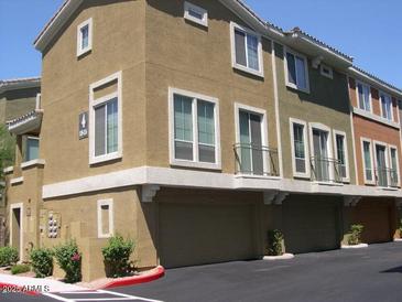 Stylish townhome featuring a private garage, balcony and well-maintained landscaping at 18250 N Cave Creek Rd # 123, Phoenix, AZ 85032