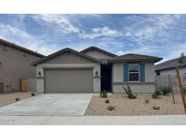 Charming single-story home with a two-car garage and low maintenance landscaping at 18374 W Poston Dr, Surprise, AZ 85387