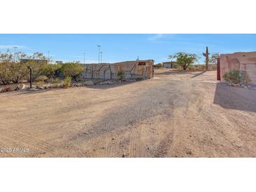 Gated entrance to property featuring desert landscaping and stone walls at 28758 N Ashbrook Ln, San Tan Valley, AZ 85144