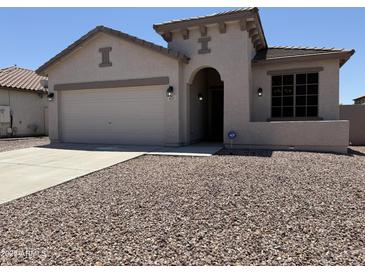 Inviting single-story home featuring desert landscaping, a two-car garage, and a covered entryway at 4117 W Allen St, Laveen, AZ 85339
