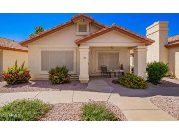 Charming single-story home with desert landscaping and a cozy front porch seating area at 1120 N Val Vista Dr # 113, Gilbert, AZ 85234