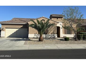 Charming single-story home showcasing a well-manicured front yard and a neutral color palette at 15655 W Berkeley Rd, Goodyear, AZ 85395