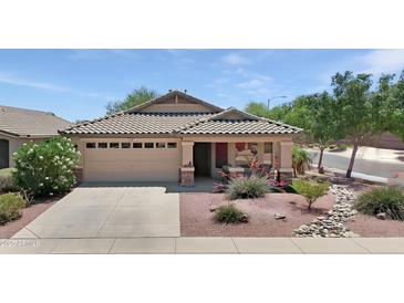 Charming single-story home featuring a well-manicured front yard with desert landscaping and an attached two-car garage at 16661 W Central St, Surprise, AZ 85388