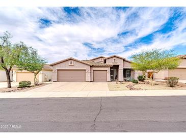 Charming single-Gathering home features a three-car garage, desert landscaping, and a welcoming entrance at 18633 W Mcneil St, Goodyear, AZ 85338