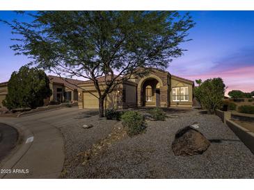 Charming single-story home featuring a well-manicured front yard and inviting stone accents at 20239 N 39Th Dr, Glendale, AZ 85308