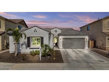 Charming single-story home with a two-car garage, desert landscaping and a neutral color scheme at 23097 N 95Th Dr, Peoria, AZ 85383