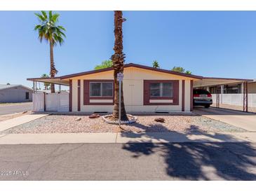 Charming single-story home with mature landscaping and a convenient carport for covered parking at 245 S 56Th St # 135, Mesa, AZ 85206