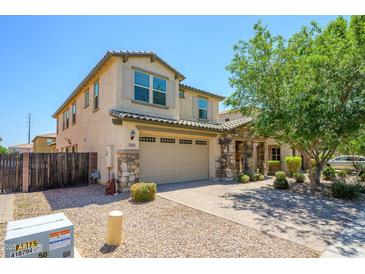 Charming two-story home featuring a stone facade, well-maintained landscaping, and a two-car garage at 3361 E Wisteria Pl, Chandler, AZ 85286