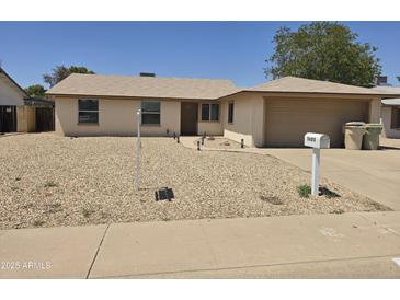 Charming single-story home featuring a low-maintenance desert landscape and inviting front entrance at 5608 W Carol Ave, Glendale, AZ 85302