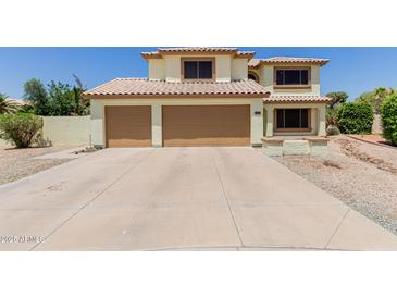 Inviting two-story home with a tile roof and three-car garage at 6276 N 75Th Ln, Glendale, AZ 85303
