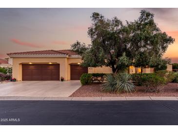 Charming single-story home with a tile roof, mature landscaping, and a spacious three-car garage at 13219 W Santa Ynez Dr, Sun City West, AZ 85375