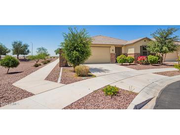 Charming single-story home with a well-manicured yard, desert landscaping, and inviting curb appeal at 17345 W Spur Dr, Surprise, AZ 85387