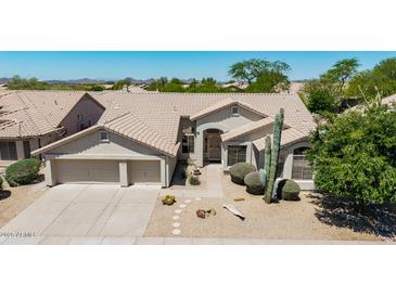 Charming home features a well-manicured desert front yard with a large, attached two-car garage at 29816 N 51St Pl, Cave Creek, AZ 85331