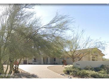Charming single-story home featuring a well-maintained yard and inviting curb appeal with a paved driveway at 34611 N Sunset Trl, Cave Creek, AZ 85331