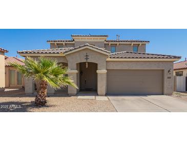 Inviting home exterior featuring desert landscaping and a two-car garage at 36179 W Cartegna Ln, Maricopa, AZ 85138