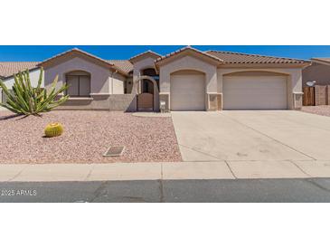 Charming single story home featuring a two car garage and well maintained desert landscaping at 11312 E Enrose St, Mesa, AZ 85207