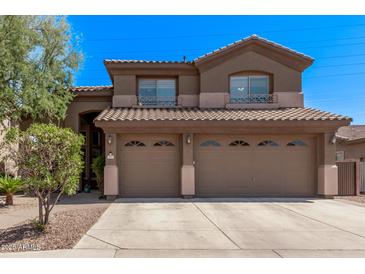 Charming two-story home with a three-car garage, landscaped front yard, and a tile roof at 1405 E Aloe Dr, Chandler, AZ 85286