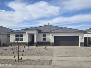 Charming single-story home with a well-maintained yard and a two-car garage at 15389 W Cottontail Ln, Surprise, AZ 85387