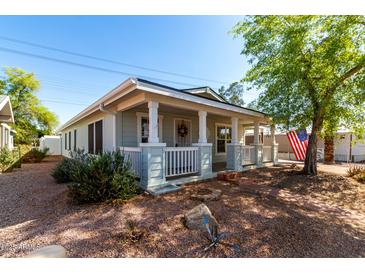 Charming single-story home with a welcoming front porch and well-maintained landscaping at 201 S Greenfield Rd # 29, Mesa, AZ 85206