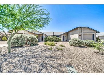 Charming single-story home with low-maintenance desert landscaping and a blue sky at 3201 W Mohawk Ln, Phoenix, AZ 85027