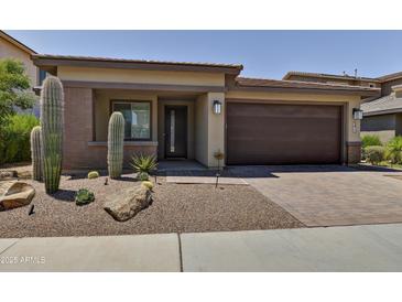 Charming home featuring desert landscaping, a brick driveway, and a covered front porch at 3411 E Louise Dr, Phoenix, AZ 85050