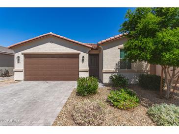 Charming single-story home with a two-car garage, desert landscaping, and a warm, inviting facade at 3415 S 75Th Dr, Phoenix, AZ 85043