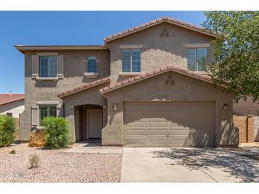 Two-story home featuring a tile roof, desert landscaping, and a two-car garage at 43670 W Mcclelland Ct, Maricopa, AZ 85138