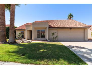 Charming single story home with a red tile roof, a two car garage, and desert landscaping in front at 5841 W Kesler St, Chandler, AZ 85226