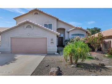 Charming single-Gathering home with a well-manicured front yard and a two-car garage at 8599 W Athens St, Peoria, AZ 85382