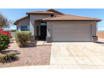 Charming single-story home with a two-car garage, desert landscaping, and a classic tile roof at 1501 E Sunland Ave, Phoenix, AZ 85040